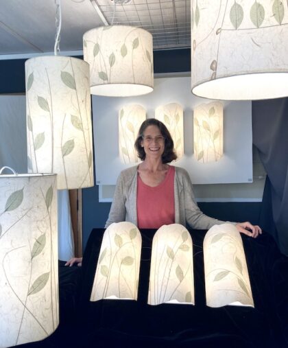 Artist Brenda Bolte with a variety of whimsical collection lights