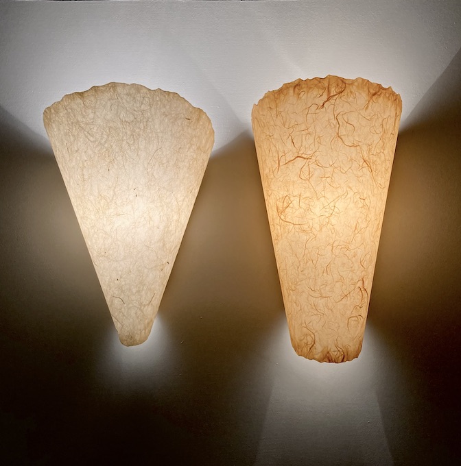 two sconces different shaped cones in natural colors